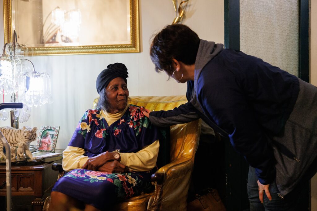 Meals on Wheels volunteer visiting with an older adult at home, showing friendly daily check-ins, companionship, and support for aging in place in Weld County